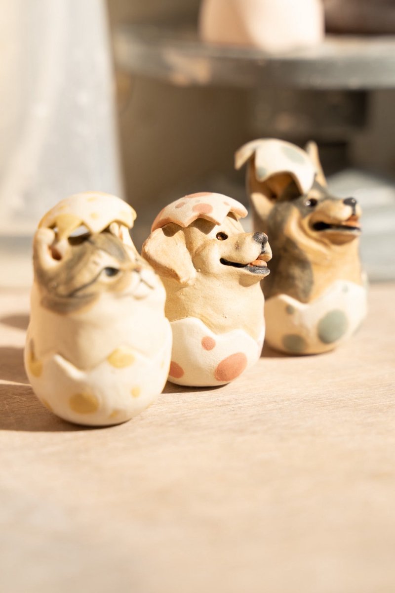 Easter-themed custom pet portrait pottery gift set featuring porcelain dog and cat roly-poly sculptures. Artisan ceramic pet figurines crafted in Singapore.