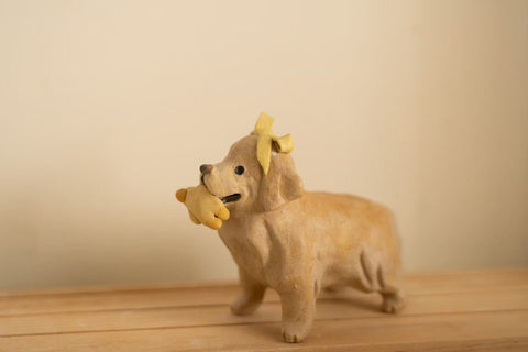 Golden with her duck toy and bow tie