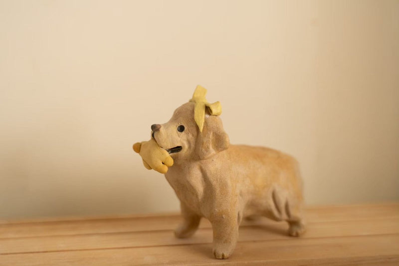 Golden with her duck toy and bow tie